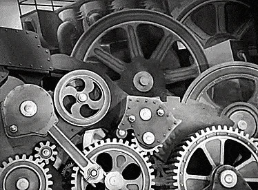 Systematic un-housing. A gif of Charlie Chaplin in Modern Times, being fed through the gears of a giant machine