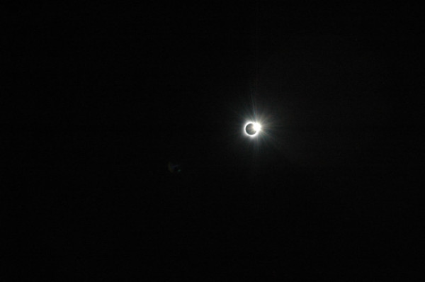 Picture of today's solar eclipse.  There is a white ring around a black circle, with a bright spot at the top-right.